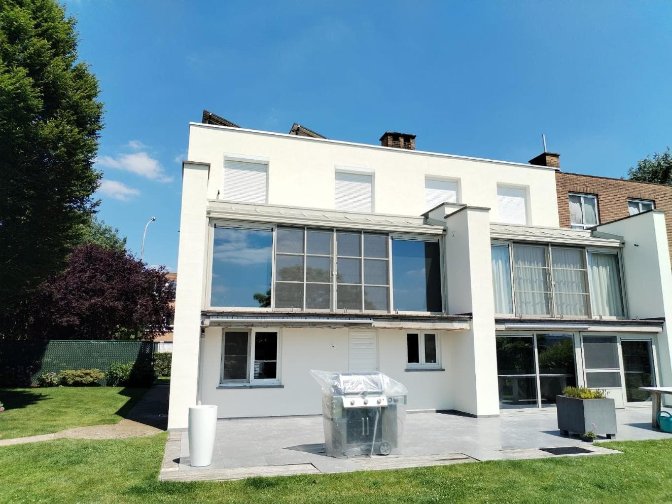Woning in Dendermonde met buitenmuurisolatie en witte crepi